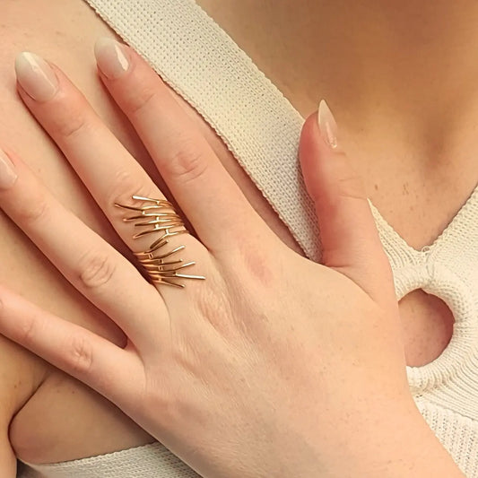 Bague ajustable en acier inoxydable doré, inspirée des lignes naturelles des racines. Une pièce élégante et puissante qui incarne la féminité libre et la force intérieure.